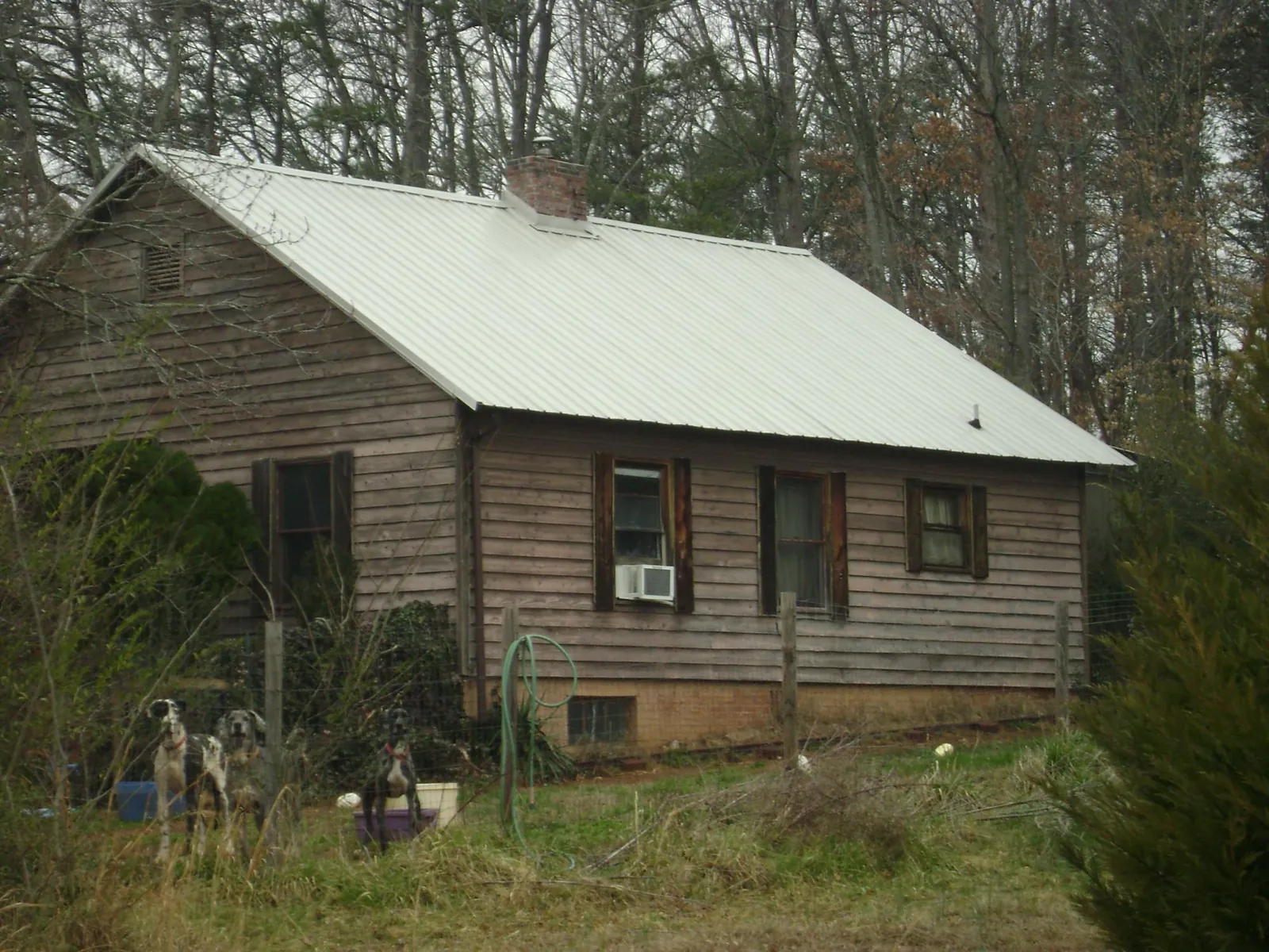 White metal roof on an old wood sided farmhouse, from a Metal Roof Installation job in Sproul